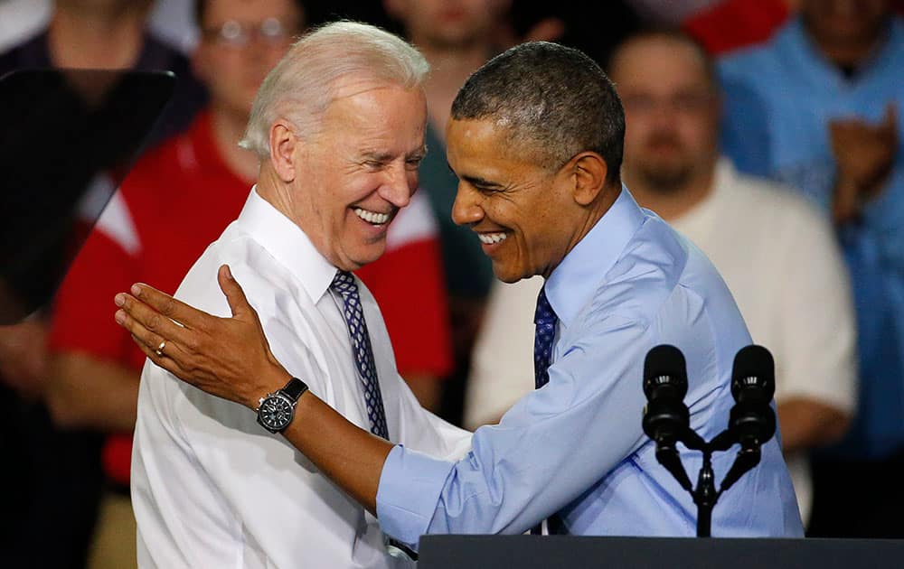 President Barack Obama is introduced by Vice President Joe Biden as he arrives at the Community College of Allegheny County West Hills Center in Oakdale, Pa.