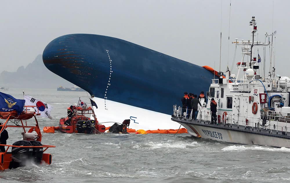 South Korean Coast Guard officers try to rescue missing passengers from a sunken ferry in the water off the southern coast near Jindo, south of Seoul, South Korea.