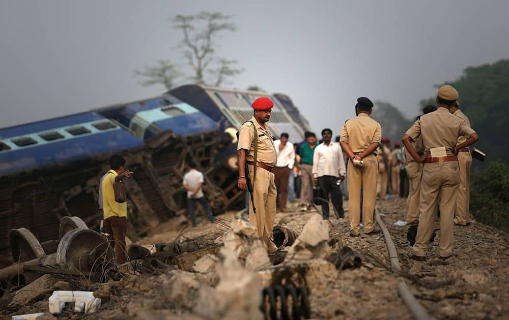 Policemen stand by a train that derailed near Jagiroad Railway Station, about 90 kilometers (56 miles) east of Guwahati.