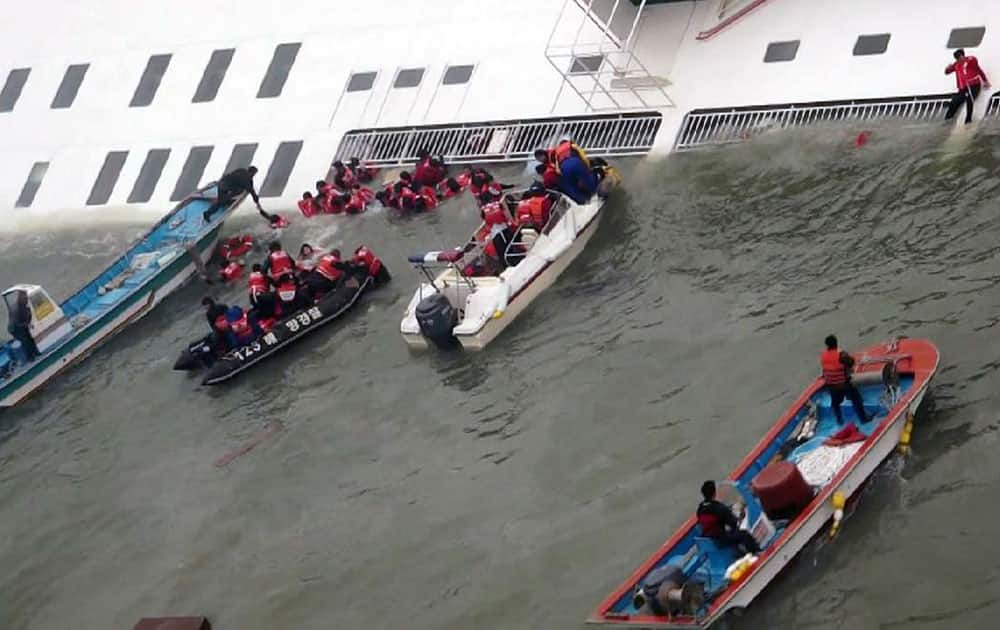 Passengers from a ferry sinking off South Korea`s southern coast, are rescued by South Korean Coast guard in the water off the southern coast near Jindo, south of Seoul.