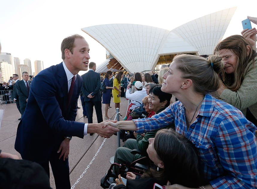 Britain`s Prince William, left, meets with people on the steps of the Sydney Opera House following a reception in Sydney.