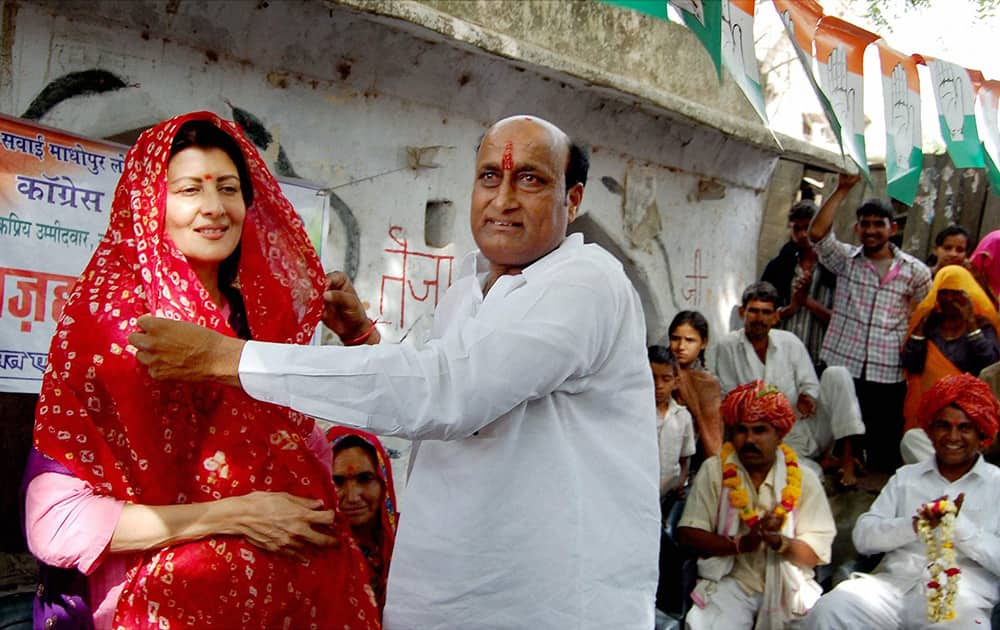 Sangeeta Bijlani is offered a `chunri` by a supporter during an election campaign in supoort of Congress candidate Mohammad Azharuddin in Tonk.