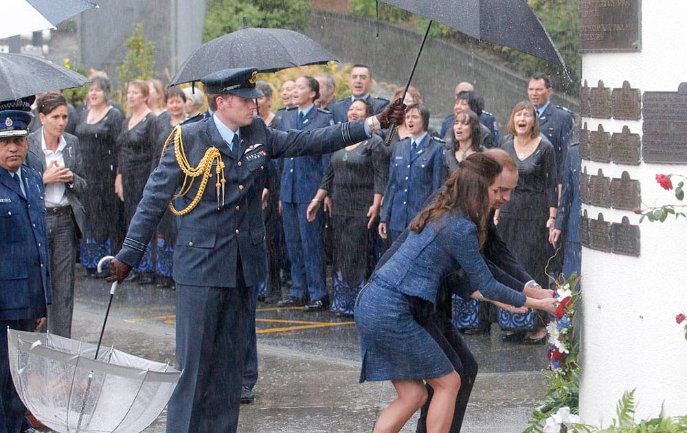 Britain`s Prince William, back right, and his wife Kate, the Duchess of Cambridge, right, lay a wreath at the Remembrance Wall while visiting the Royal New Zealand Police College in Wellington, New Zealand.