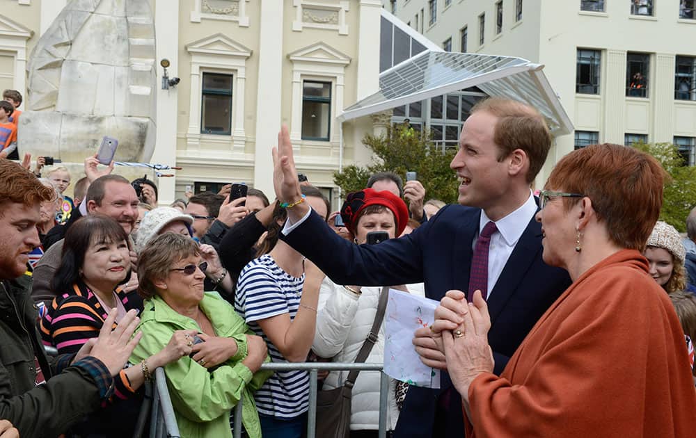 Britain`s Prince William walks with Wellington Mayor Celia Wade-Brown, right, as he meets the crowd during a walkabout in the Civic Square in Wellington, New Zealand.
