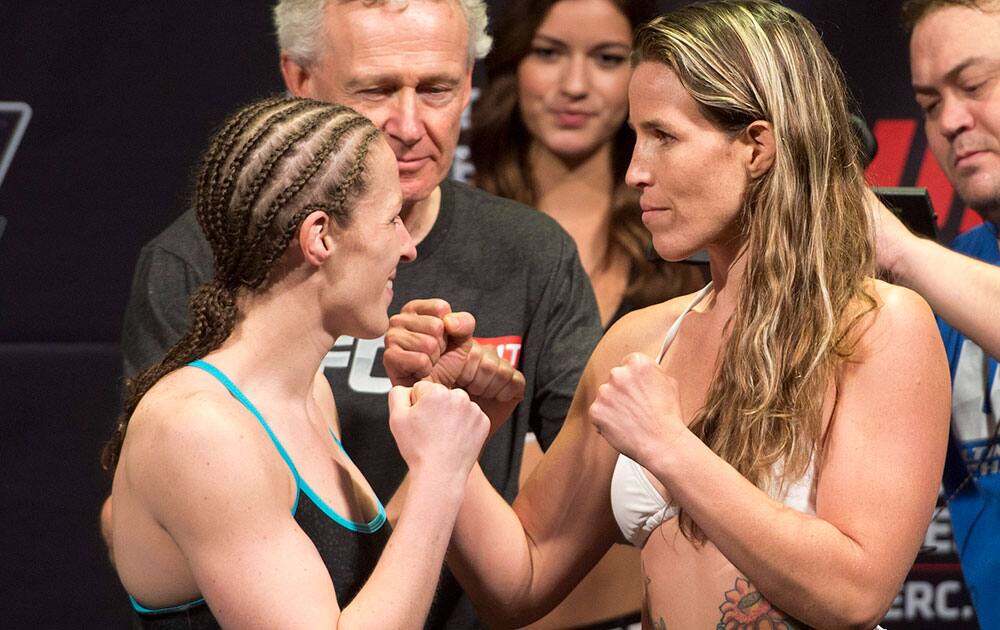 Bantamweights Sarah Kaufman, left, of Victoria British Columbia, and Leslie Smith, of the United States, face off at the weigh in for the UFC`s `The Ultimate Fighter Nations` event in Quebec City.