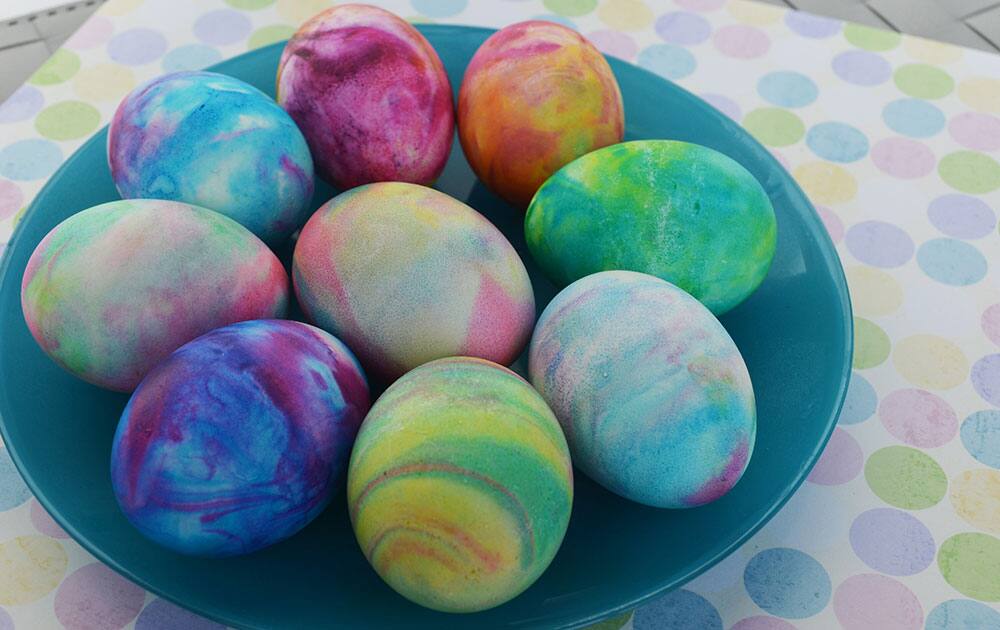 This photo provided by A Thrifty Mom shows the use of shaving cream and liquid food coloring to dye hard-boiled eggs which gives them a tie-dyed effect. It`s a tactile project most kids will enjoy. 