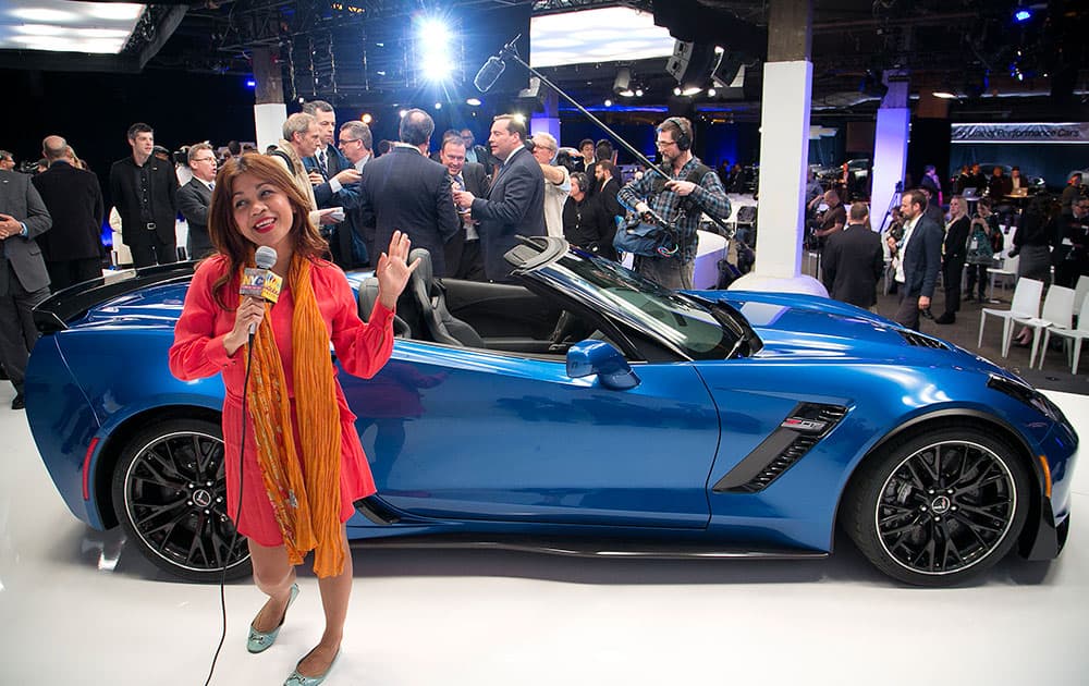 Members of the media surround the Chevrolet 2015 Corvette Z06 convertible at the New York International Auto Show, in New York.