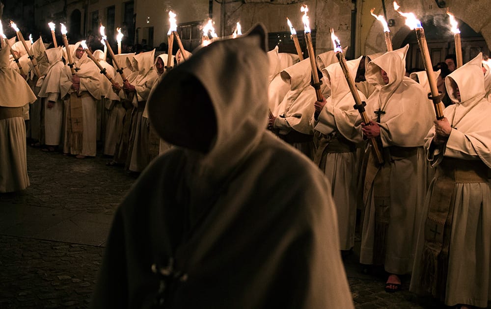 Penitents from `Cristo de la Buena Muerte` or `Good Dead Christ` brotherhood take part in a procession in Zamora, Spain. Hundreds of processions take place throughout Spain during the Easter Holy Week.