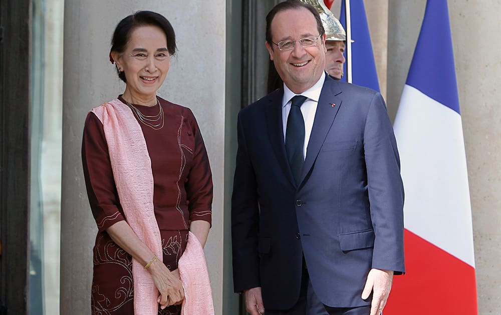 France`s President Francois Hollande poses for photographers with Myanmar`s opposition leader Aung San Suu Kyi prior to a meeting at the Elysee Palace in Paris.