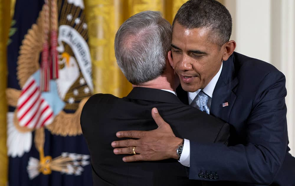 President Barack Obama embraces Dr. Joel C. Hunter, senior pastor of Northland, A Church Distributed, in Longwood, Fla., during the Easter Prayer Breakfast, in the East Room of the White House in Washington. 