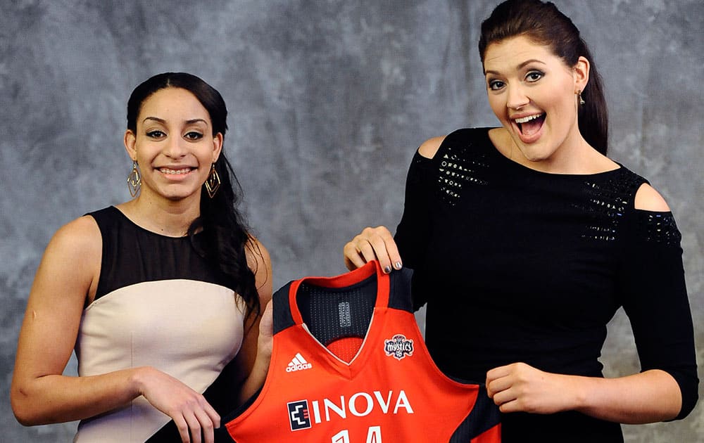 Connecticut`s Bria Hartley, left, and Stefanie Dolson, hold up a Washington Mystics jersey after Hartley was traded from the Seattle Storm to the Washington Mystics to play with Dolson in the WNBA basketball draft in, Monday, April 14, 2014, in Uncasville, Conn. 