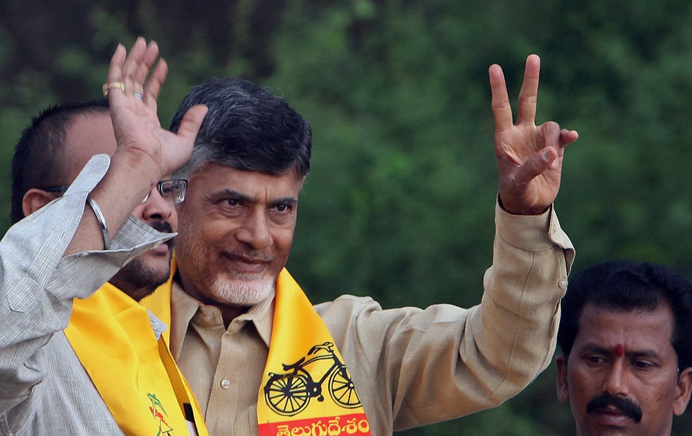 Telugu Desam Party (TDP) President and former Chief Minister of Andhra Pradesh state, N. Chandrababu Naidu greets his supporters during an election campaign rally in Hyderabad.