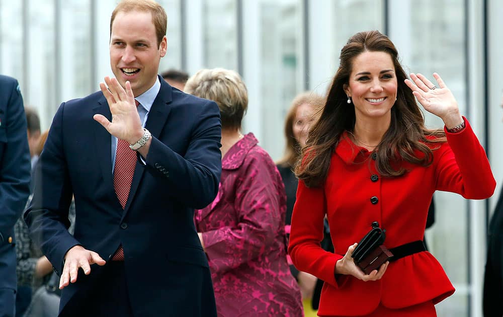 Britain`s Prince William, left, and his wife Kate, the Duchess of Cambridge, wave after their tour of the new visitors center at the Christchurch botanical gardens in Christchurch, New Zealand.