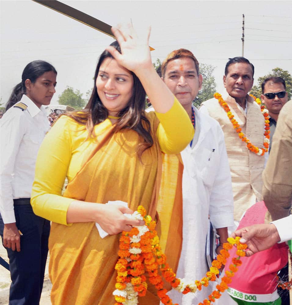 Actress and Congress candidate from Meerut, Nagma waves to her supporters during an election campaign for Congress candidate from Pilibhit seat, in Pilibhit.