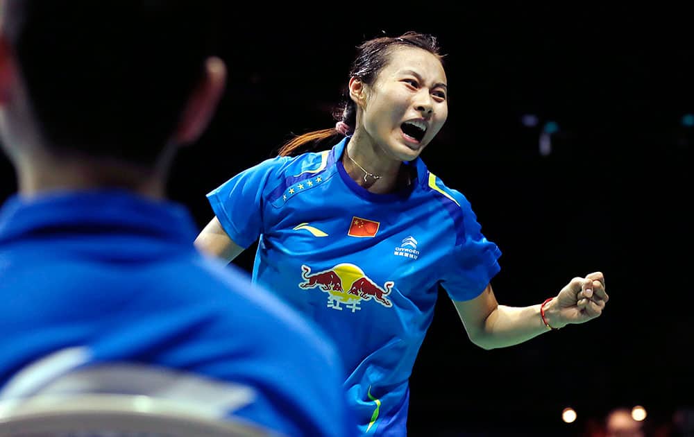 Wang Yihan, right, of China celebrates after scoring a point against Li Xuerui of China during their final match at the Singapore Open Badminton championship in Singapore.