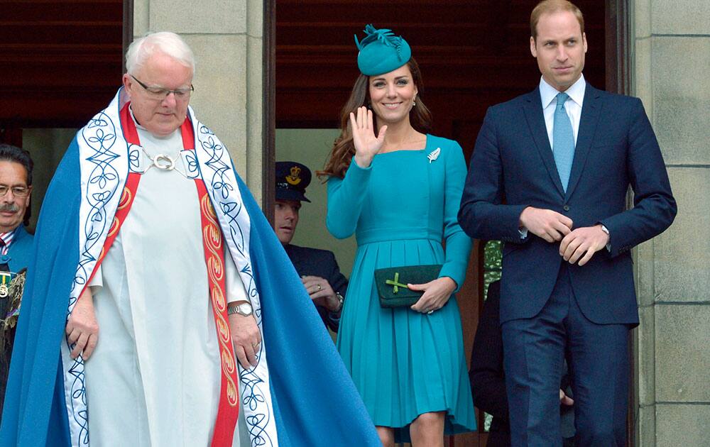 Britain`s Prince William, right, and his wife Kate, the Duchess of Cambridge, center, are accompanied by the Dean of St. Paul`s Cathedral, the Very Rev. Trevor James, left, after a Palm Sunday service at the Cathedral in Dunedin, New Zealand.