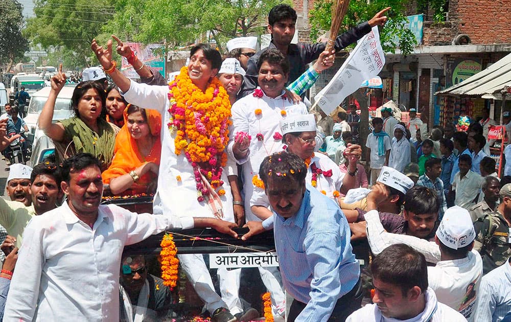 AAP candidate from Amethi Kumar Vishwas waves to supporters on the way to file his nomination papers for Amethi parliamentary seat, in Amethi.