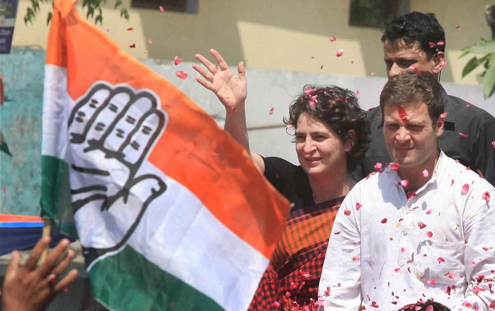 Congress Vice President Rahul Gandhi with his sister Priyanka Vadra waves to supporters on the way to file his nomination papers for Amethi parliamentary seat, in Amethi.