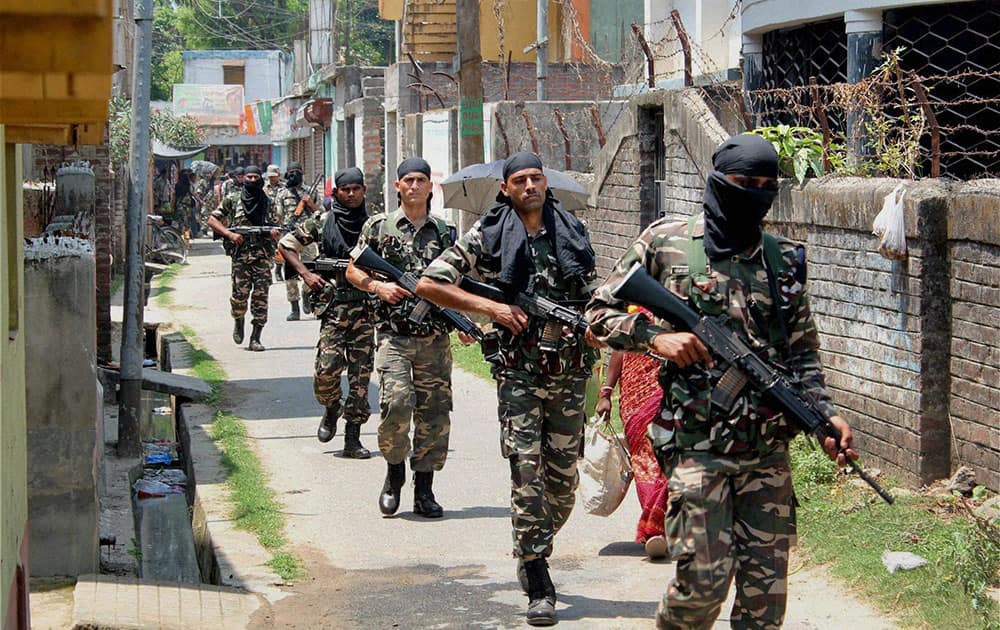 Paramilitary jawans conduct a flag march ahead of Lok Sabha elections at Balurghat in South Dinajpur district of West Bengal.