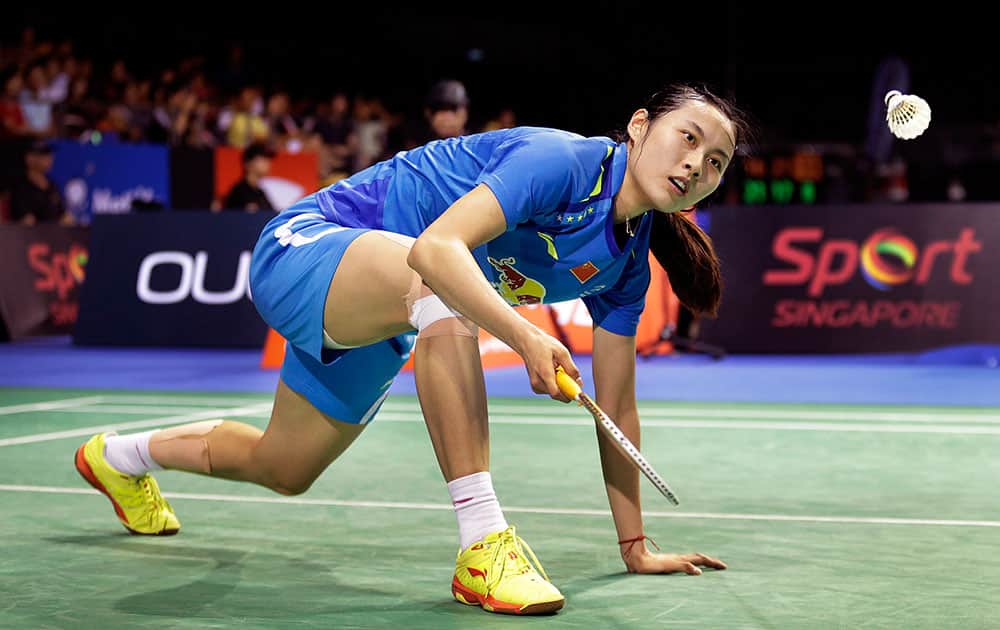 Wang Yihan of China returns a shot to Han Li of China during their semifinal match at the Singapore Open Badminton championship.