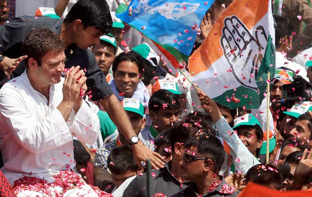 Congress Vice President Rahul Gandhi waves to supporters on the way to file his nomination papers for Amethi parliamentary seat, in Amethi.