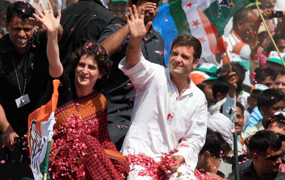 Congress Vice President Rahul Gandhi with his sister Priyanka Vadra waves to supporters on the way to file his nomination papers for Amethi parliamentary seat, in Amethi.
