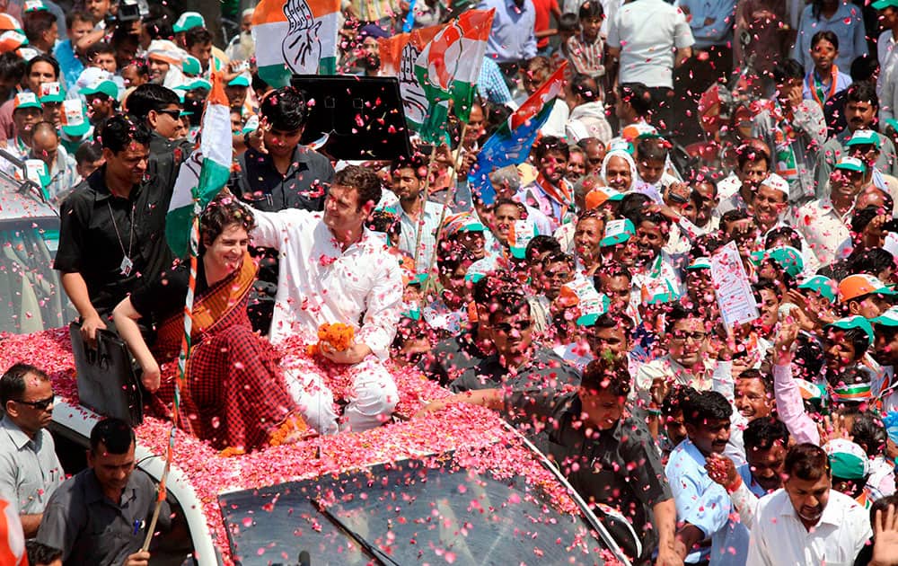 Supporters shower flower petals on Congress Vice President Rahul Gandhi as he along with his sister Priyanka Vadra is on the way to file his nomination papers for Amethi parliamentary seat, in Amethi.