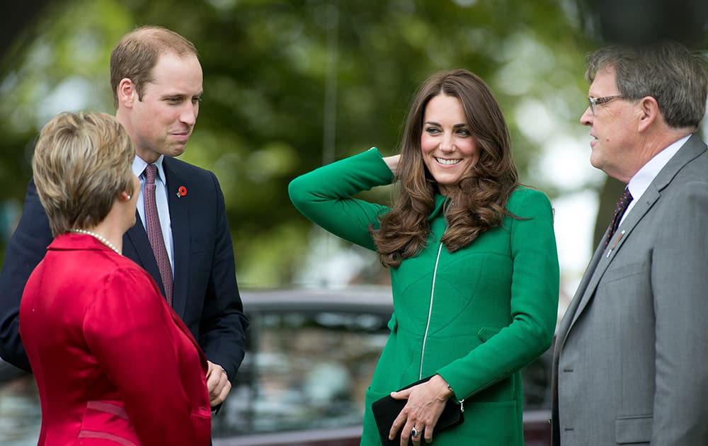 Britain`s Prince William, second left, and his wife Kate, Duchess of Cambridge, second right, talk with Mayor Jim Mylchreest, right, and his Wife Robyn in Cambridge.