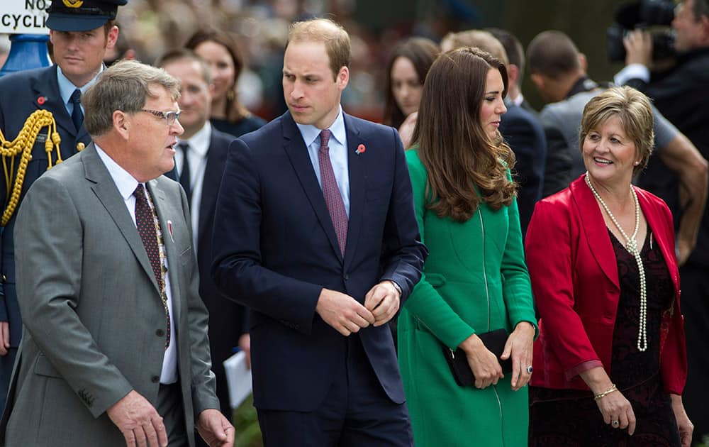 Britain`s Prince William, second left, and his wife, Kate, Duchess of Cambridge, second right, chat with Mayor Jim Mylchreest, left, and his wife Robyn before placing two roses on the War Memorial during their visit to Cambridge, New Zealand.