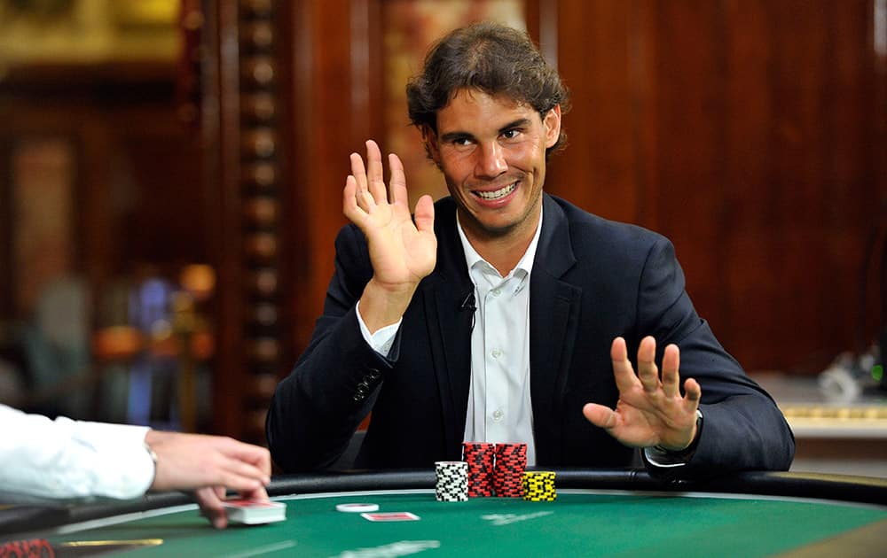 Rafael Nadal, of Spain, gestures during a game of poker with professional player Vanessa Selbst at Casino de Monte Carlo, in Monaco.