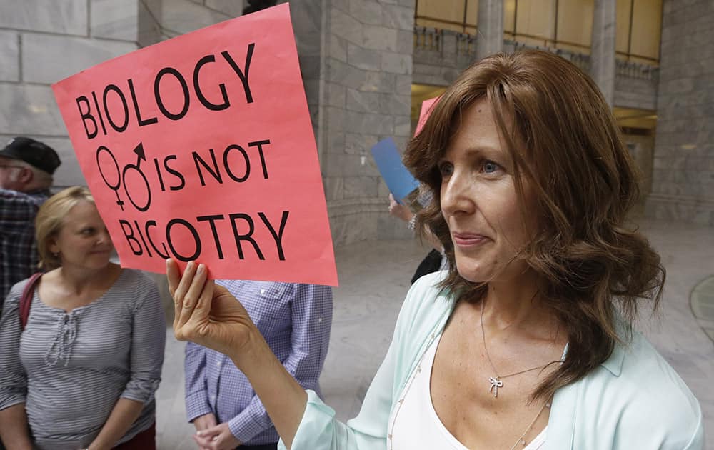 Ali Bell, Bountiful, holds her sign with other supporters of Utah`s same-sex marriage ban who gathered at the Utah State Capitol, in Salt Lake City, to stand up for `traditional marriage` a day after a federal appeals court heard arguments about the constitutionality of the law.