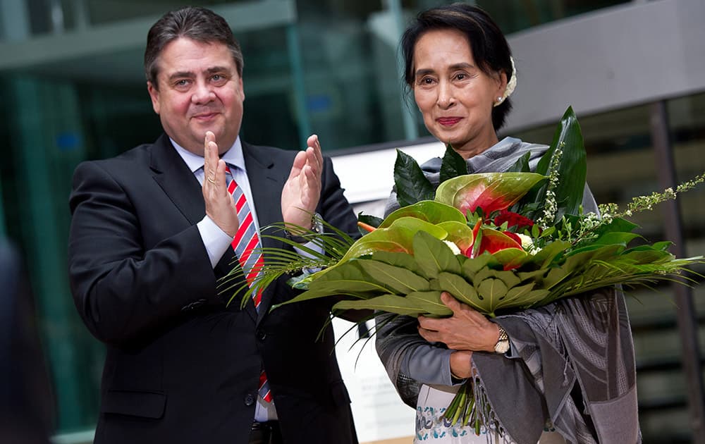 Myanmar Opposition Leader Aung San Suu Kyi, right, received flowers by German Economy and Energy Minister Sigmar Gabriel during Aung San Suu Kyi`s awarding ceremony with the Willy Brandt Award of the Social Democratic Party in Berlin.