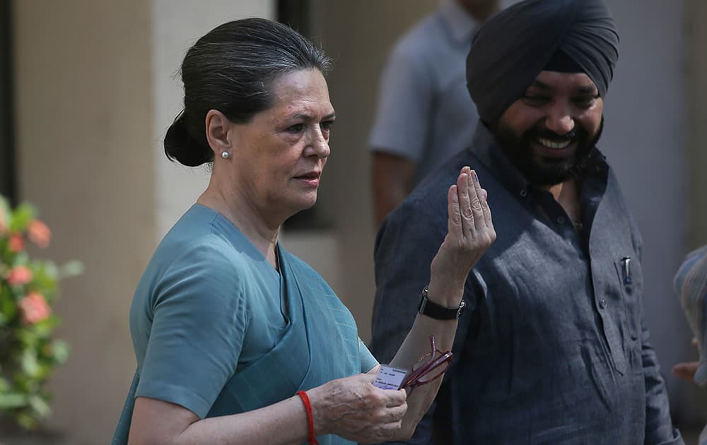 Sonia Gandhi displays the ink mark on her finger after casting her vote during parliamentary elections in New Delhi.