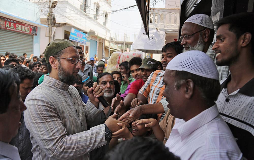 All India Majlis Ittehadul Muslimeen (AIMIM) president Asaduddin Owaisi contesting in the parliamentary elections greets people during his campaign in Hyderabad.