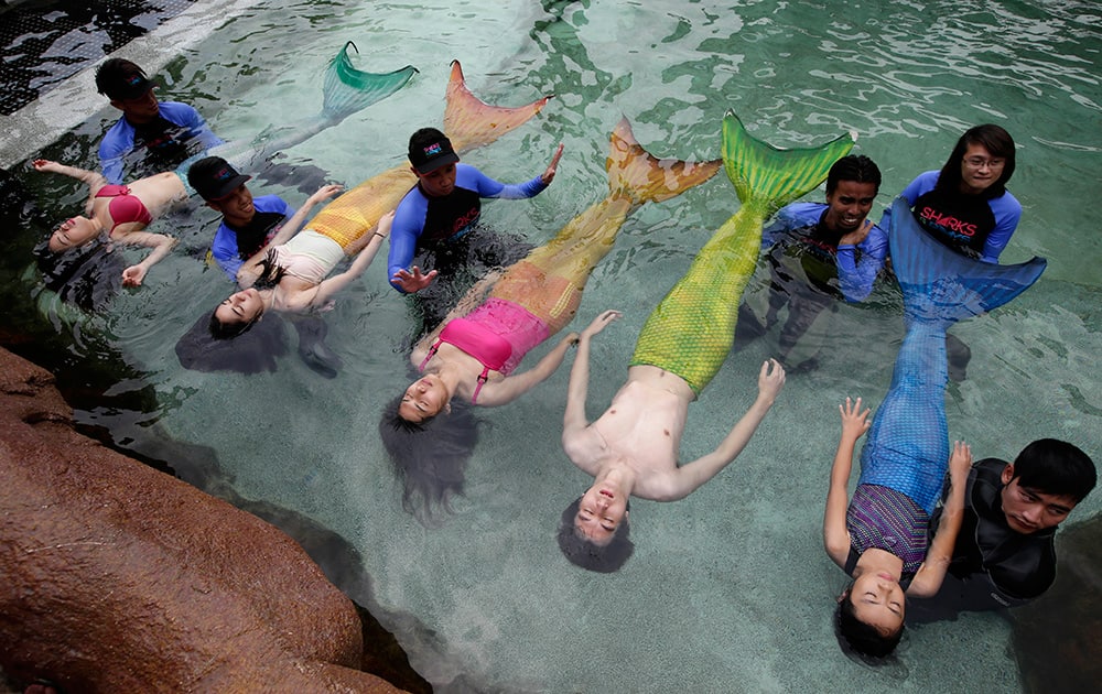 Swimming instructors conduct lessons to children and adults donning mermaid costumes in the latest attraction at the country`s largest oceanarium in Manila, Philippines.