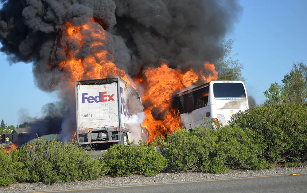 The FedEx tractor-trailer crossed a grassy freeway median in Northern California and slammed into the bus carrying high school students on a visit to a college. At least nine were killed in the fiery crash, authorities said.