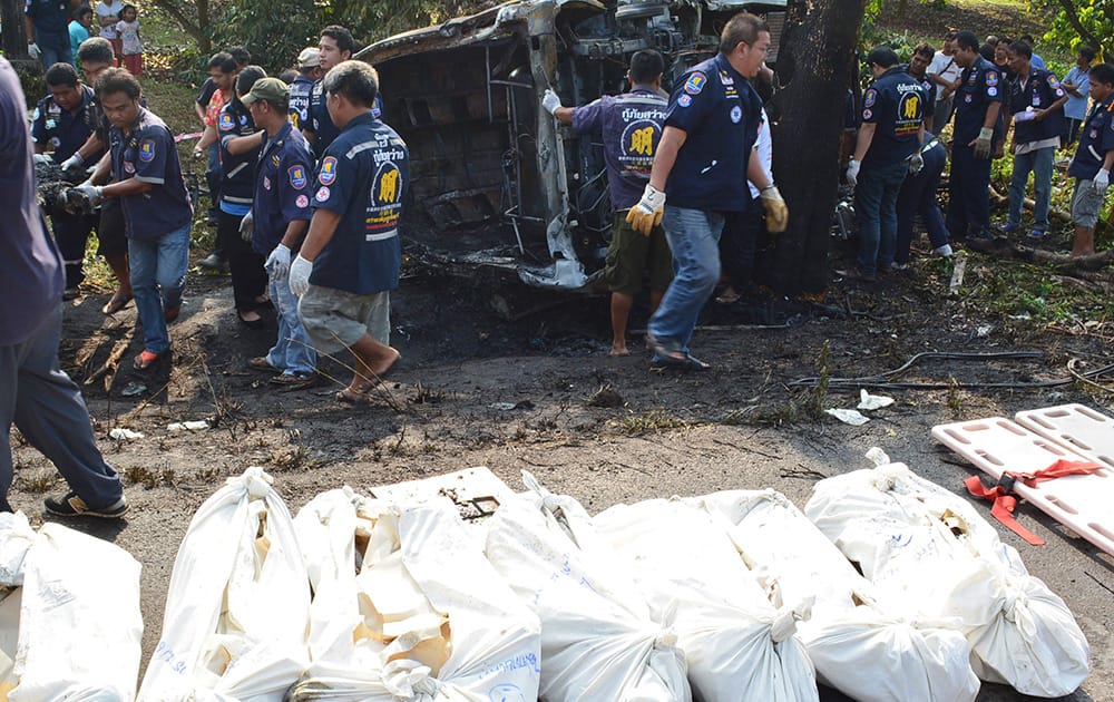 Bodies of passenger van victims are put on the roadside near the crash site by charity workers in Ta Mai district of Chanthaburi province, eastern Thailand. The accident killed at least 8 passengers and injured 13 others, Thai media reported.