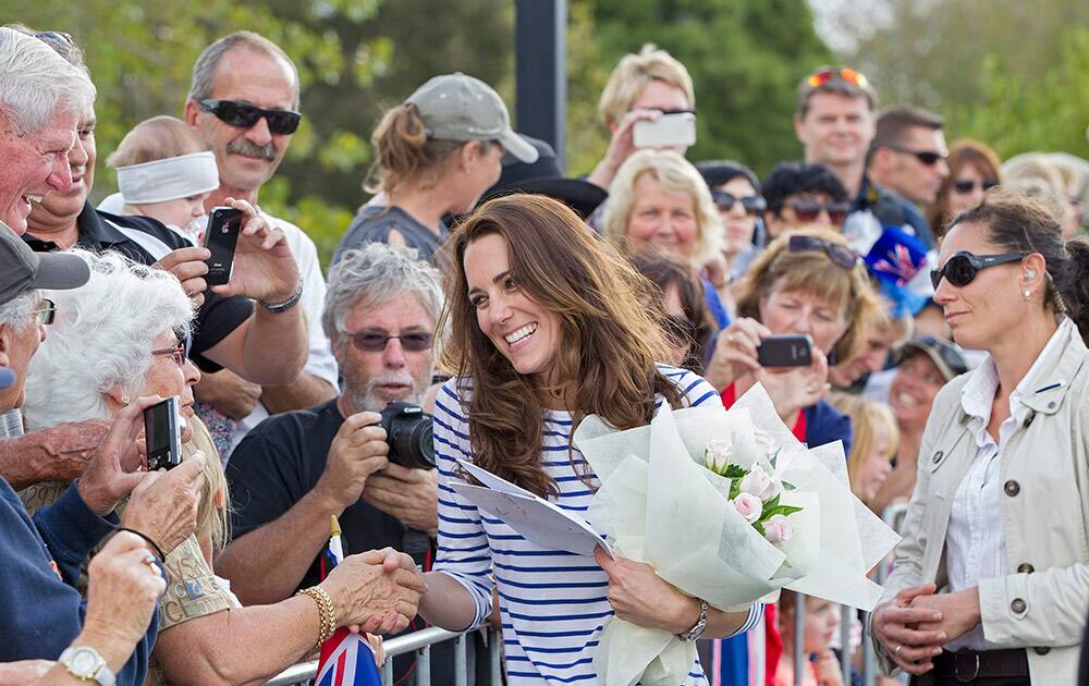 Britain`s Kate, the Duchess of Cambridge, center, meets waiting crowds after she traveled by Sealegs craft to Westpark Marina in Auckland, New Zealand.