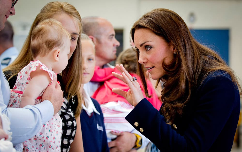 Britain`s Kate, the Duchess of Cambridge, right, meets with families at the Royal New Zealand Air Force base Whenuapai in Auckland.