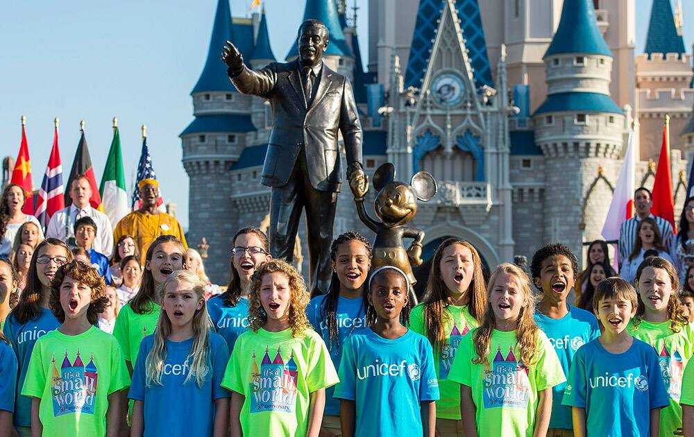 photo made available by Walt Disney World shows a children`s chorus singing `It’s a small world` at the Magic Kingdom in Lake Buena Vista, Fla.