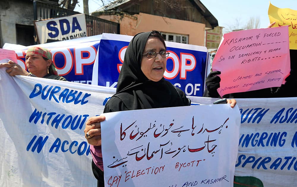 Activists of Jammu Kashmir women`s democratic forum hold placards during a protest in Srinagar.