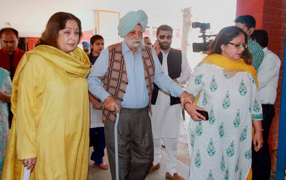 BJP candidate from Chandigarh Kirron Kher with her father 101yrs old Retd. Col. Thakar Singh and sister Kanwal Thakar Singh to cast their vote at a polling station for Lok sabha election 2014 in Chandigarh.