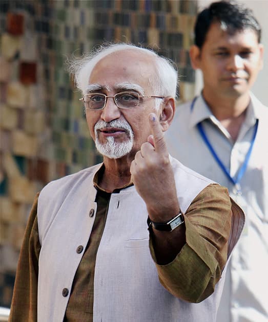 Vice President Hamid Ansari shows his ink-marked finger after casting his vote at Nirman Bhawan polling station during voting for the third phase of the Lok Sabha elections.