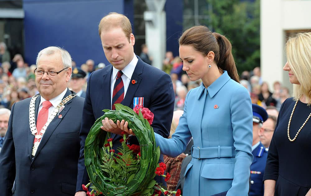 Britain`s Prince William, second left, and his wife Kate, the Duchess of Cambridge, second right, lay a wreath at the War Memorial in Seymour Square, Blenhiem, New Zealand.