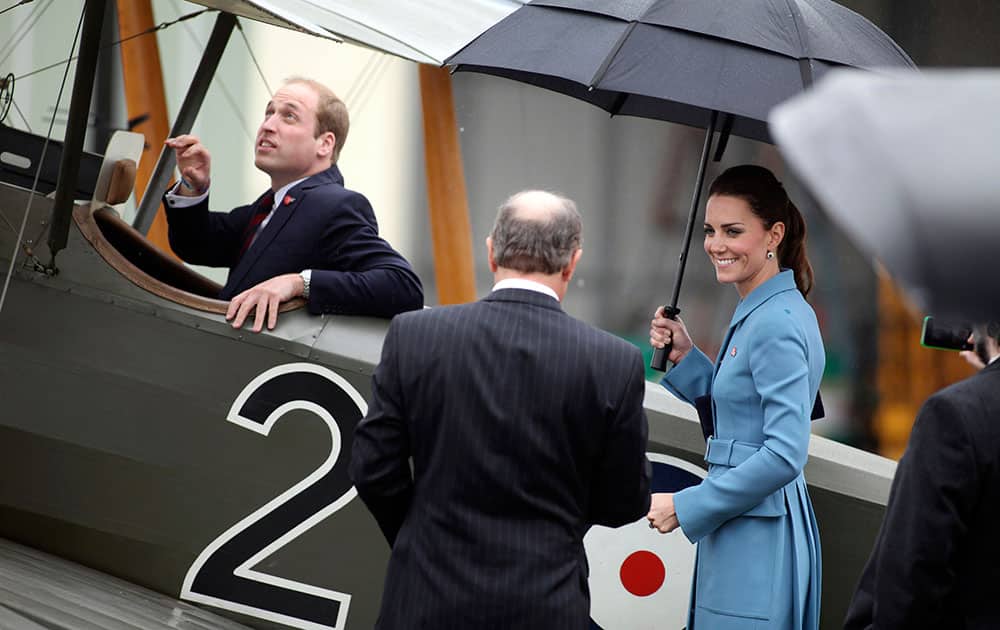 Britain`s Prince William, left, sits in a classic Sopwith Pup as he and his wife Kate, the Duchess of Cambridge, tour the Omaka Aviation Heritage Centre in Blenheim, New Zealand.