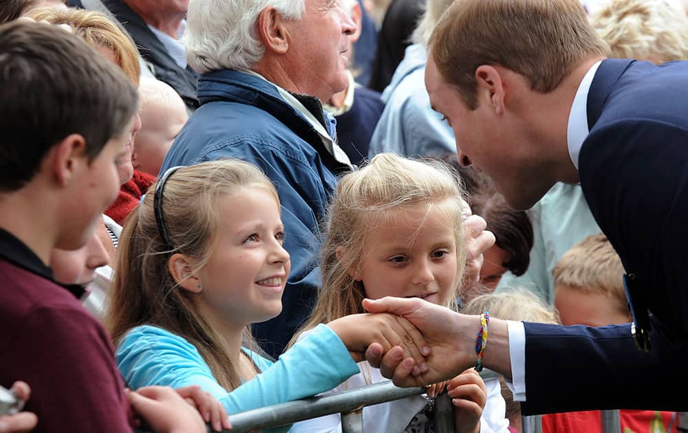 Britain`s Prince William, right, chats with the public during a walkabout in Seymour Square, Blenhiem, New Zealand.