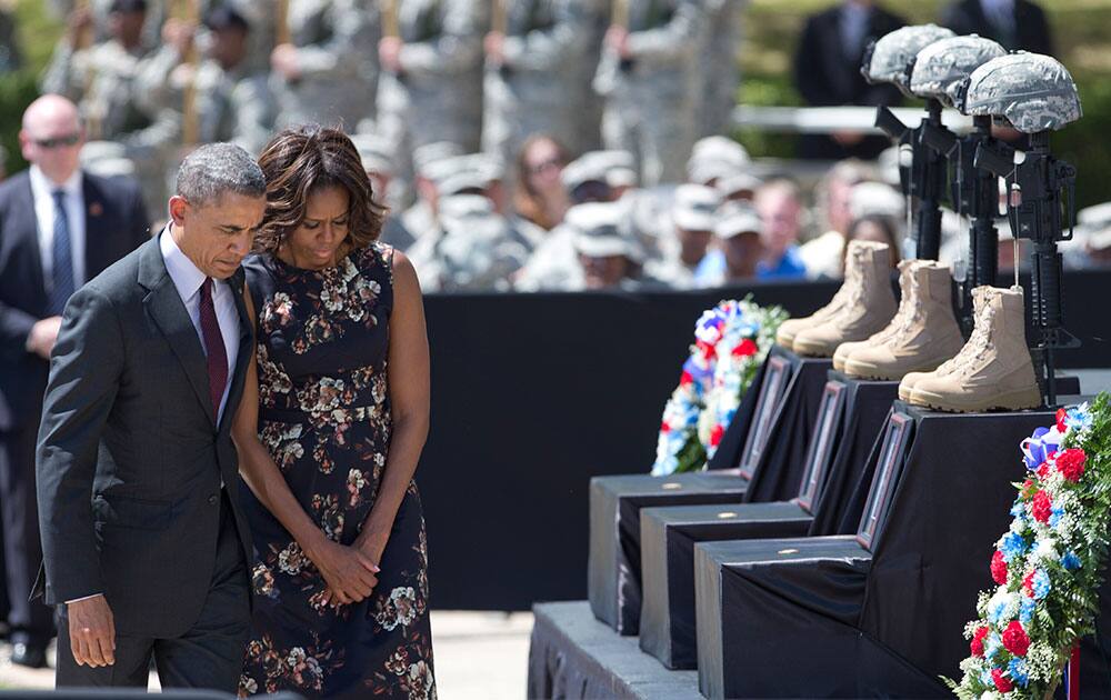 President Barack Obama and first lady Michelle Obama turn to leave after paying their respects during a memorial ceremony, at Fort Hood Texas, for those killed there in a shooting last week. President Barack Obama is reprising his role as chief comforter as he returns once again to a grief-stricken corner of America to mourn with the families of those killed last week at Fort Hood and offer solace to the nation.