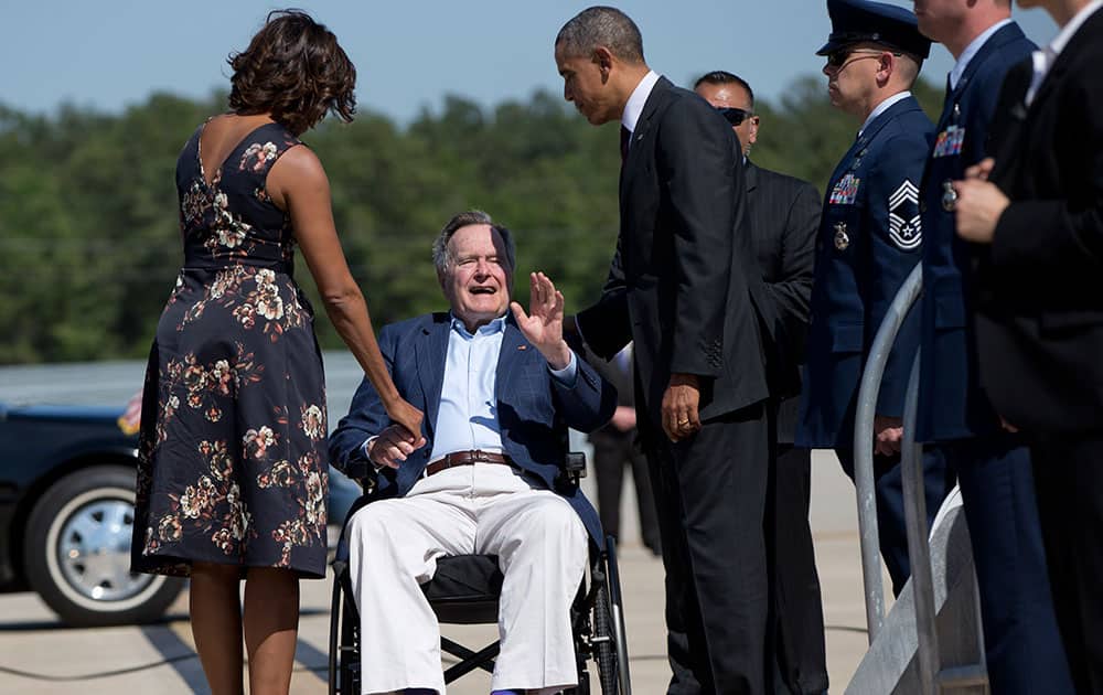 President Barack Obama and first lady Michelle Obama are greeted by former President George H.W. Bush as they arrive on Air Force One at George Bush Intercontinental Airport, in Houston.