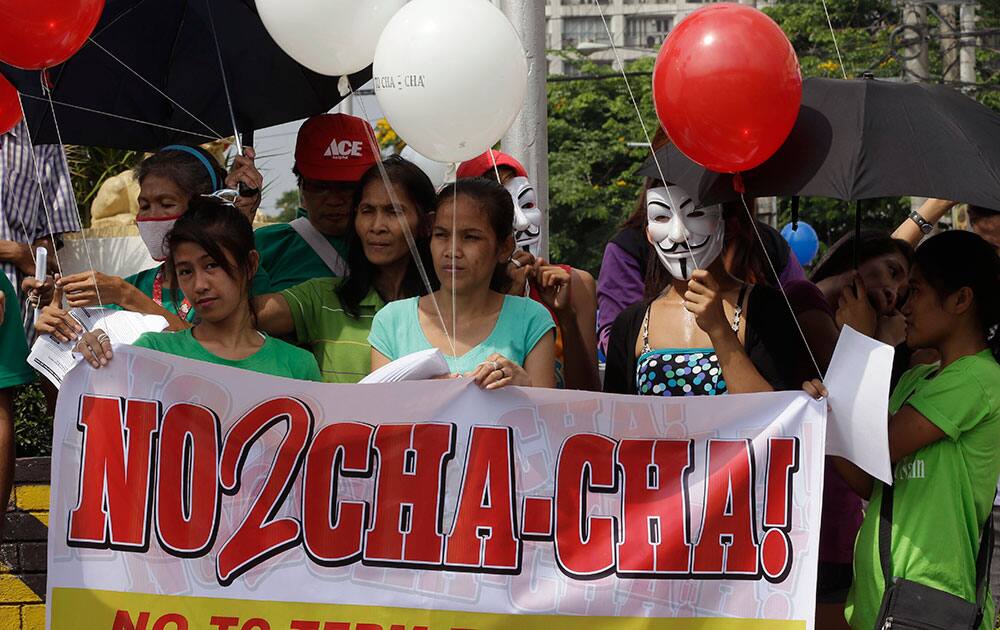 Protesters display a banner and balloons during a rally in Quezon city northeast of Manila, Philippines to oppose plans by the country`s legislature to change the country`s constitution.