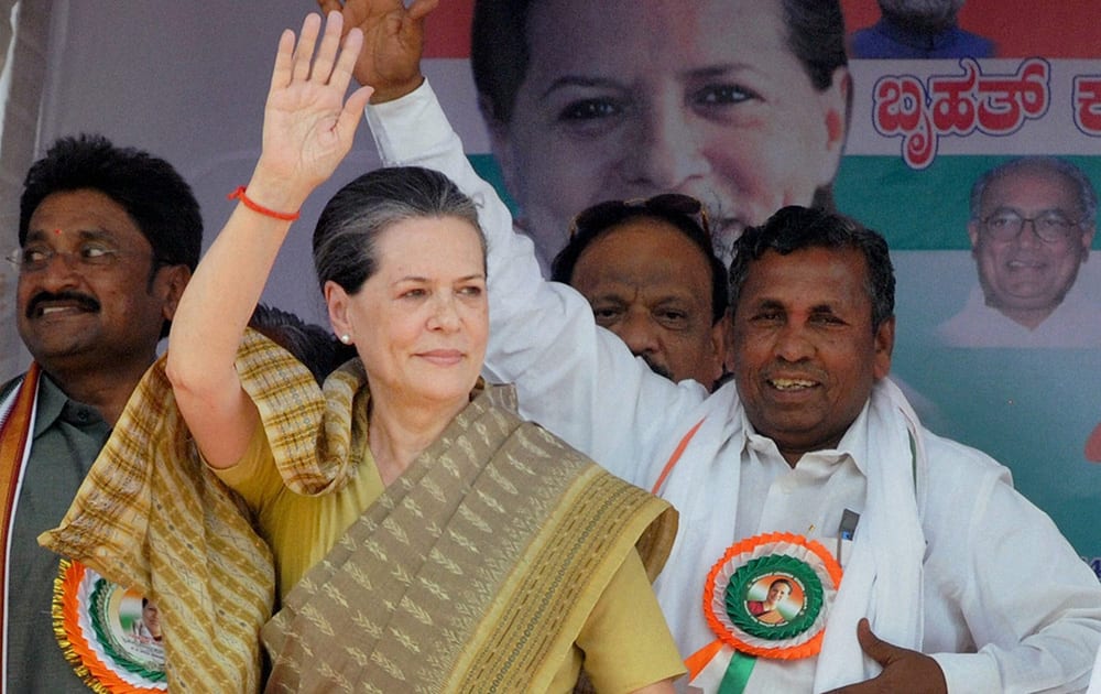 Sonia Gandhi waves to people during an election rally in support of party candidate K H Muniyappa in Kolar near Bengaluru.